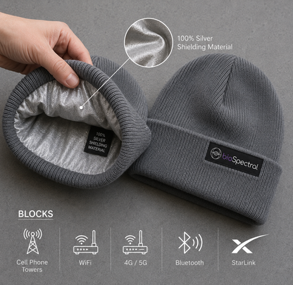 Man wearing the BioSpectral Signal Shield Beanie in grey outdoors in a mountain setting