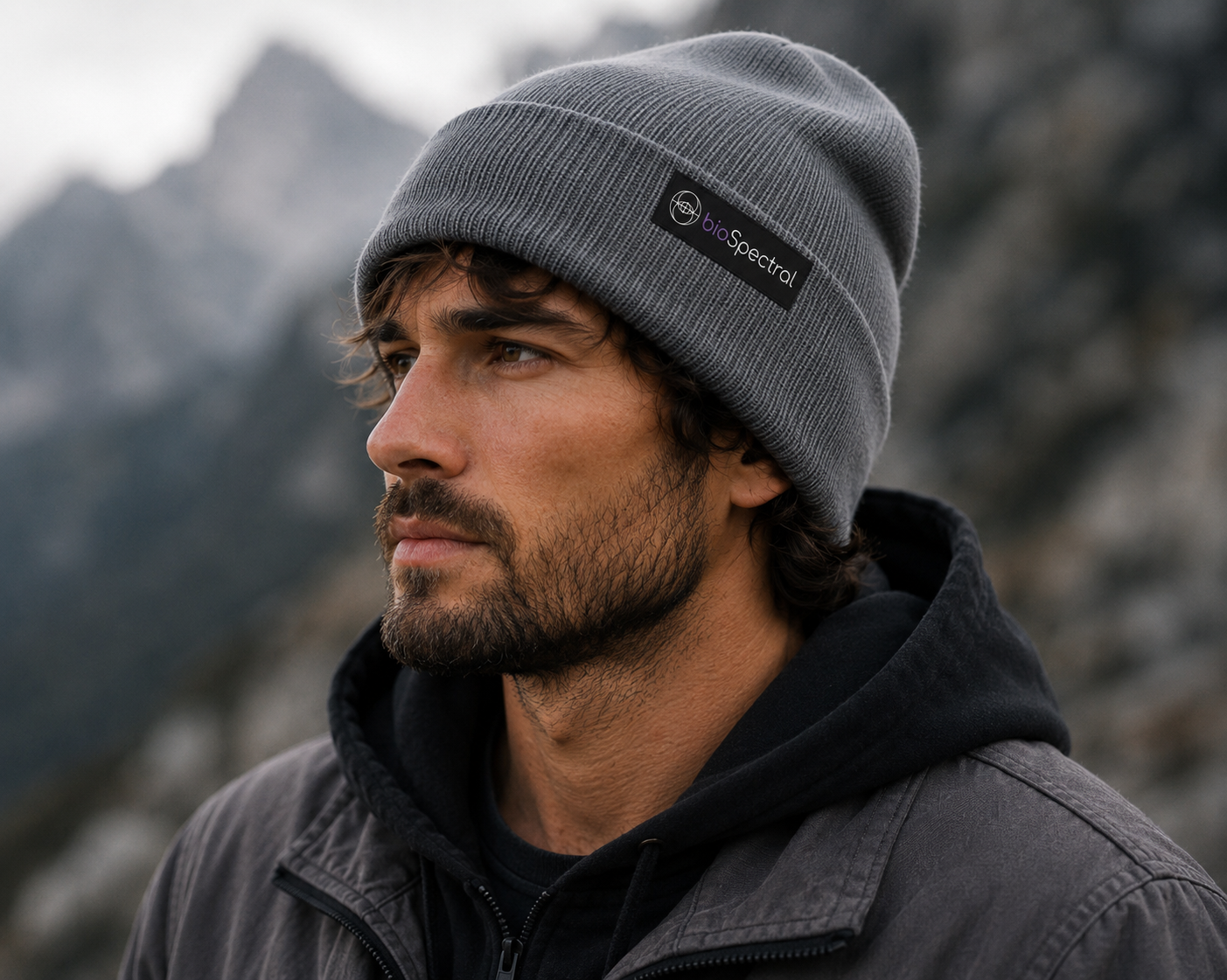 BioSpectral Signal Shield Beanie in grey, folded flat product view showing ribbed cuff and woven brand label